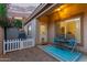 Cozy patio area with outdoor seating, a small table, and a charming welcome mat at the door at 14864 W Riviera Dr, Surprise, AZ 85379
