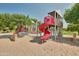 Community playground featuring slides, climbing structures, and picnic area in background at 14864 W Riviera Dr, Surprise, AZ 85379