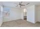 Bright bedroom with neutral carpet, large window for natural light, and access to the ensuite bathroom at 14870 W Encanto Blvd # 2006, Goodyear, AZ 85395