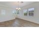 Bonus Room featuring wood-look floors, a chandelier, and natural light from large windows at 14870 W Encanto Blvd # 2006, Goodyear, AZ 85395