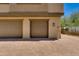 Two car garage on paver driveway with FDC sprinkler system connection for fire department at 14870 W Encanto Blvd # 2006, Goodyear, AZ 85395