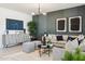 Well-appointed living room with modern decor, a plush sofa, and contemporary lighting fixtures at 1648 S 241St Ave, Buckeye, AZ 85326