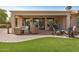 View of the covered patio with outdoor furniture and artificial turf, ideal for low-maintenance living at 16972 W Anasazi Ct, Surprise, AZ 85387