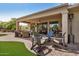 Relaxing covered patio with multiple seating areas, perfect for outdoor dining and entertaining at 16972 W Anasazi Ct, Surprise, AZ 85387