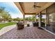 Spacious covered patio with brick flooring, comfortable seating, and scenic backyard view at 16972 W Anasazi Ct, Surprise, AZ 85387