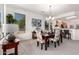 Dining area with carpet, an elegant chandelier, and great natural light from surrounding windows at 16972 W Anasazi Ct, Surprise, AZ 85387