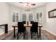 Dining area featuring updated lighting, light color palette, and window with plantation shutters at 16972 W Anasazi Ct, Surprise, AZ 85387
