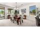 Dining area with carpet, an elegant chandelier, and views of the outdoors through the window at 16972 W Anasazi Ct, Surprise, AZ 85387
