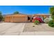 Charming home featuring a desert landscaped front yard and a spacious three-car garage at 16972 W Anasazi Ct, Surprise, AZ 85387