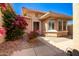Cozy house featuring a tiled roof, desert landscaping and flowering plants at 16972 W Anasazi Ct, Surprise, AZ 85387