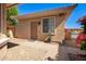 Inviting entry of a charming desert home, complemented by stone pathways and mature landscaping at 16972 W Anasazi Ct, Surprise, AZ 85387