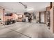 Spacious three-car garage with ample storage and work space, and overhead lighting at 16972 W Anasazi Ct, Surprise, AZ 85387