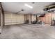 Well-lit garage with ample storage, two car doors, and lots of functional space at 16972 W Anasazi Ct, Surprise, AZ 85387