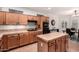 Kitchen with an island, tile countertops, gas cooktop, built-in oven, and adjacent dining area at 16972 W Anasazi Ct, Surprise, AZ 85387