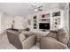 Bright living room with carpet, built-in shelves, neutral colors and plenty of seating at 16972 W Anasazi Ct, Surprise, AZ 85387