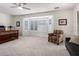 Spacious main bedroom with a bay window, comfortable seating area, and neutral carpeting at 16972 W Anasazi Ct, Surprise, AZ 85387