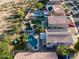 Aerial view shows beautiful pool, landscaping, solar panel, and desert environment in community at 1723 E Pontiac Dr, Phoenix, AZ 85024