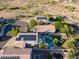 Beautiful aerial shot showcases the property with private pool, patio, lush yard, desert setting and solar panels at 1723 E Pontiac Dr, Phoenix, AZ 85024