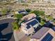 Overhead view of homes with tile roofs and solar panels, nestled within a desert landscape at 1723 E Pontiac Dr, Phoenix, AZ 85024