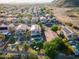 Aerial view showcasing multiple homes, manicured landscaping, desert vista, swimming pools and solar panels in community at 1723 E Pontiac Dr, Phoenix, AZ 85024