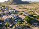 Picture of home from the air with neighborhood, pool, landscaping, desert backdrop, and solar panels at 1723 E Pontiac Dr, Phoenix, AZ 85024