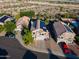 High-angle view of a residential area with homes featuring tile roofs, swimming pools, and solar panels at 1723 E Pontiac Dr, Phoenix, AZ 85024