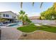 Lush backyard featuring a sparkling pool, artificial grass, hammock, and lounge chairs perfect for outdoor relaxation at 1723 E Pontiac Dr, Phoenix, AZ 85024