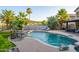 Relaxing backyard with a luxurious pool, rock features, lounge chairs, and manicured landscaping at 1723 E Pontiac Dr, Phoenix, AZ 85024