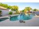 Lush backyard with a refreshing pool, rock waterfall, jacuzzi, and ample space for outdoor activities at 1723 E Pontiac Dr, Phoenix, AZ 85024