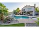 Gorgeous backyard oasis with a sparkling pool, a rock waterfall, and a lush green landscape at 1723 E Pontiac Dr, Phoenix, AZ 85024