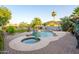 Expansive backyard with a lagoon style pool, a spa, and lush landscaping with privacy and serenity at 1723 E Pontiac Dr, Phoenix, AZ 85024