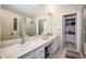 Bright bathroom with double sink vanity, large mirror, and walk-in shower with neutral toned tile at 1723 E Pontiac Dr, Phoenix, AZ 85024