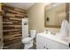 Stylish half bathroom with a modern vanity, decorative wood accent wall, and attractive fixtures at 1723 E Pontiac Dr, Phoenix, AZ 85024
