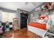 Spacious bedroom with hardwood floors, large window, and decor that would delight any  at 1723 E Pontiac Dr, Phoenix, AZ 85024