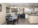 Cozy dining area featuring a wooden table, decorative shelving, and a view of the well-equipped kitchen space at 1723 E Pontiac Dr, Phoenix, AZ 85024