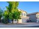 Attractive two-story house with a lush green tree in the front yard, enhancing curb appeal at 1723 E Pontiac Dr, Phoenix, AZ 85024