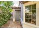 Welcoming front entrance with a decorative security door, stone pathway, and lush landscaping at 1723 E Pontiac Dr, Phoenix, AZ 85024
