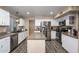Modern kitchen with stainless steel appliances, granite countertops, a center island, and ample cabinet space at 1723 E Pontiac Dr, Phoenix, AZ 85024