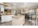 Open kitchen and dining area with granite countertops, island, and stainless steel appliances at 1723 E Pontiac Dr, Phoenix, AZ 85024