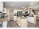 Spacious kitchen with stainless steel appliances, granite countertops, a center island, and light wood floors at 1723 E Pontiac Dr, Phoenix, AZ 85024