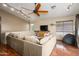 Spacious living room featuring ceiling fan, hardwood floors, comfortable seating, and plenty of natural light at 1723 E Pontiac Dr, Phoenix, AZ 85024
