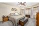 Comfortable bedroom featuring carpeted floors, ceiling fan, dresser and trunk at the foot of the bed at 1723 E Pontiac Dr, Phoenix, AZ 85024