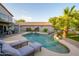 Inviting backyard pool with a waterfall feature, surrounded by lush landscaping and lounge seating at 1723 E Pontiac Dr, Phoenix, AZ 85024