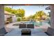 Inviting backyard oasis featuring a sparkling pool, spa, rock waterfall, and outdoor seating area, perfect for entertaining at 1723 E Pontiac Dr, Phoenix, AZ 85024