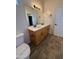 Bright bathroom featuring double sinks, wood-look tile flooring, and neutral color palette at 1736 W Pollack St, Phoenix, AZ 85041