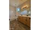 Double-vanity bathroom with sleek tile flooring, providing a modern and functional space at 1736 W Pollack St, Phoenix, AZ 85041