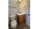 Bathroom features a toilet with seal, a vanity with black hardware, and a large mirror at 1736 W Pollack St, Phoenix, AZ 85041