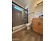 Modern bathroom with a glass-enclosed shower, maple cabinets, and black hardware at 1736 W Pollack St, Phoenix, AZ 85041