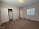 This bedroom features neutral walls, carpet and a closet for storage at 1736 W Pollack St, Phoenix, AZ 85041