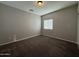 This bedroom features neutral walls, carpet and a window to let in natural light at 1736 W Pollack St, Phoenix, AZ 85041
